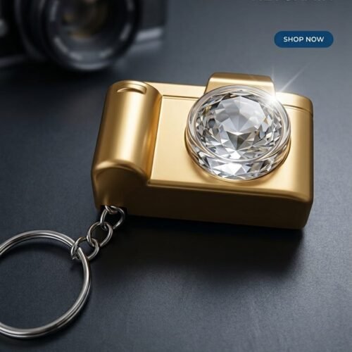 luxury metallic golden camera shaped keychain featuring a large cut crystal led glowing lens on a dark surface