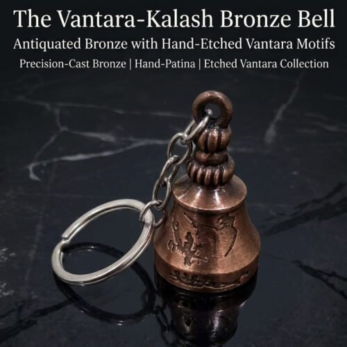 antique finish hand-embossed brass divine pooja bell keychain with link chain and a round wooden tag on a brass pedestal base