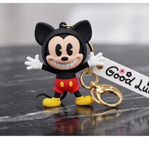 cute 3d silicone mickey mouse cartoon character keychain with white good luck wrist strap and gold hardware clasp on a dark marble surface